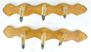 An oak board whip rack, set with six deer slots,