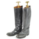 A pair of traditional black leather riding boots,