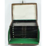 A leather fly fishing case, the top opening to reveal six numbered trays,