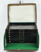 A leather fly fishing case, the top opening to reveal six numbered trays,