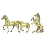 Three brass figures of horses in various stances,