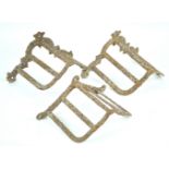 A pair of cast iron bridle racks, together with another similar,