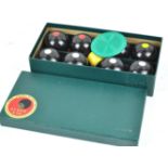 A boxed set of Brookes and Adams carpet bowls,