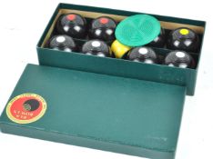 A boxed set of Brookes and Adams carpet bowls,