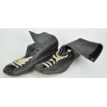 A pair of black leather boxing boots with white shoe laces,