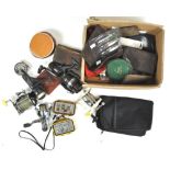 A box of fishing reels, spinners,
