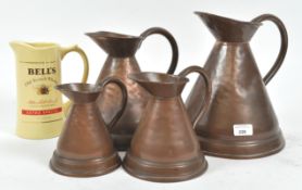 Four copper ale measures and a Bells jug,