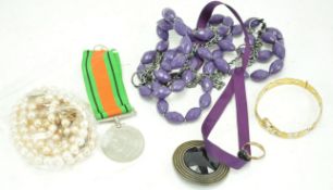 A group of assorted costume jewellery including a 9ct gold chain and a medal