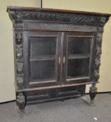 A heavily carved oak cabinet top,