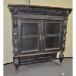 A heavily carved oak cabinet top,