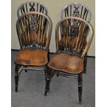 A set of four oak wheel back chairs,