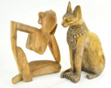 A carved rubber wood figure of a stylized lady,