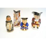 Three pottery Toby jugs and a stein in the form of a monk,