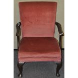 A pink velvet fireside chair