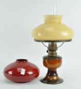 A West German pottery oil lamp marked beneath " Atellier Renee Hand Gemacht and a red glazed