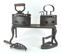 Three cast iron irons and a trivet