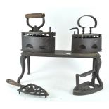 Three cast iron irons and a trivet