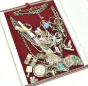 A red jewellery box containing silver jewellery