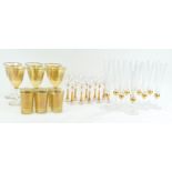 A set of ten gilt champagne flutes, 24cm high,