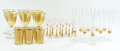 A set of ten gilt champagne flutes, 24cm high,