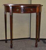 A mahogany side table with shaped front,