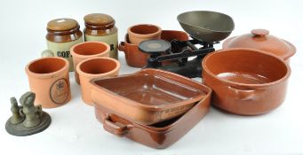 A set of scales and some terracotta kitchen containers