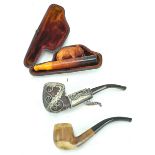 A tub of smoking pipes and an amber cheroot elephant holder,