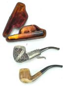 A tub of smoking pipes and an amber cheroot elephant holder,