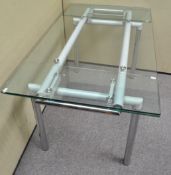 A metal legged dining table with extending glass top,