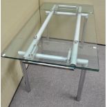 A metal legged dining table with extending glass top,