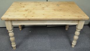 A pine kitchen table with two frieze drawers on turned legs,