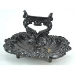 A 19th century cast iron boot scraper with dish base,