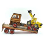 A wooden toy lorry and trailer,