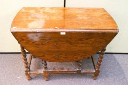 An oak gate leg table with barley twist legs,