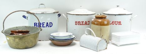 An assortment of kitchenalia, including enamel flour and bread bins,