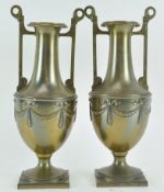 A pair of embossed neo-clasical Adam style brass vases,