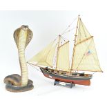 A resin figure of a cobra and a model of a boat