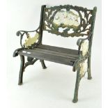 A child's cast metal miniature garden bench,