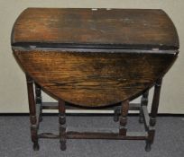 An oak drop leaf table, 72cm high x 42cm wide,