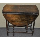 An oak drop leaf table, 72cm high x 42cm wide,