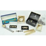 A collection of assorted costume jewellery to include gold plated cuff links, coins,