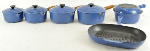 A group of Le Creuset blue cookware