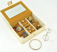 A cream jewellery box of vintage jewellery and specs