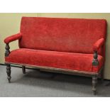 A Victorian mahogany two seat sofa upholstered in red,