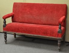 A Victorian mahogany two seat sofa upholstered in red,