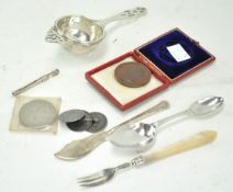 A silver medicine spoon and other metalware