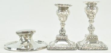 A pair of silver candlesticks,