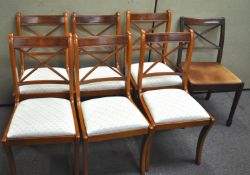 A set of seven dining chairs with drop in seats,