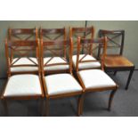 A set of seven dining chairs with drop in seats,