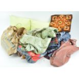 A group of assorted fabrics and cushions